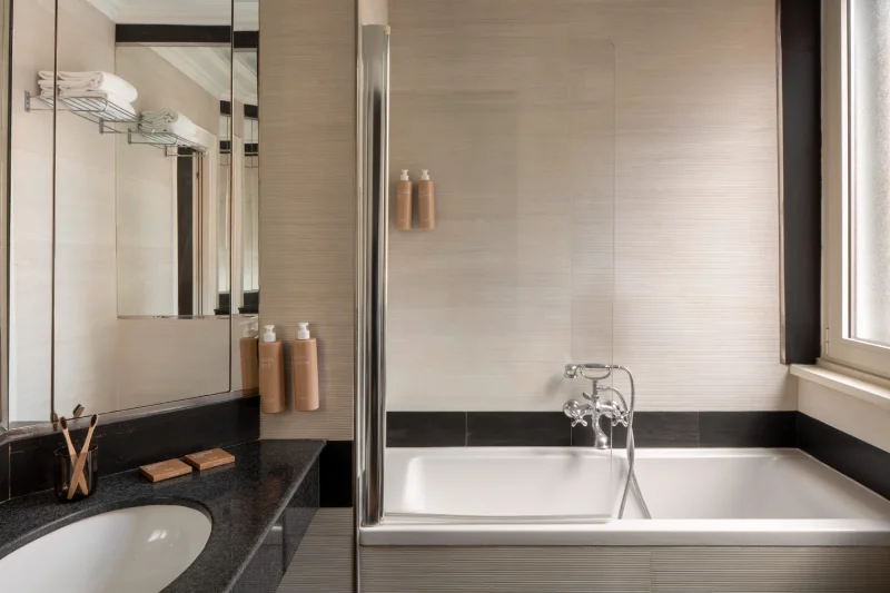 Contemporary bathroom with bathtub, black vanity and glass shower near Piazza della Repubblica - The Hotel Britannia, BZAR hotels in Rome
