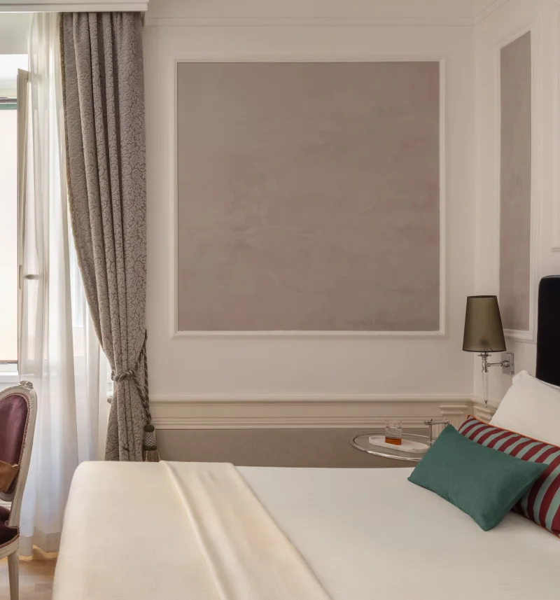 Room detail with double bed, damask curtains, colourful cushions and side table near Santa Maria Maggiore - The Hotel Britannia, BZAR hotels in Rome