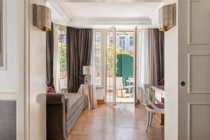 Suite detail with bed, striped headboard, elegant drapes and TV near the Rome Opera House - The Hotel Britannia, BZAR hotels in Rome